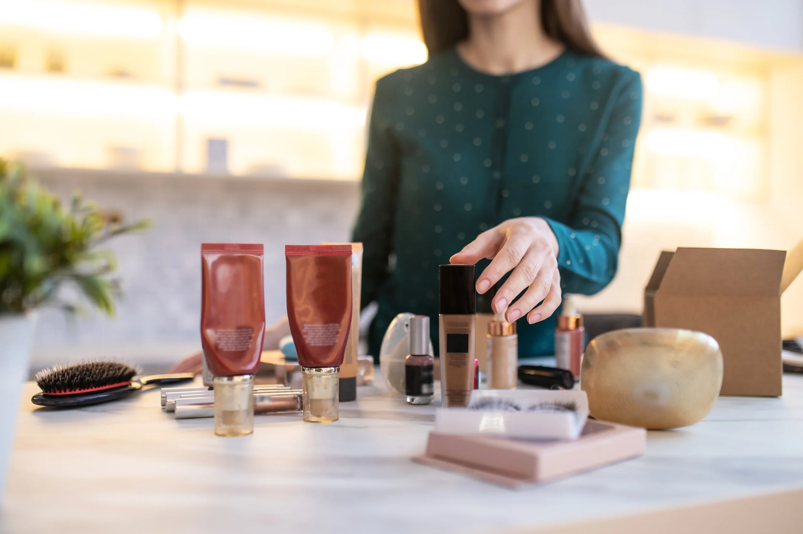 A woman is reaching for cosmetics in a shop